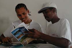 Peter & Denzel at Grace's Restaurant in Punta Gorda, reading about Roy Sanchez