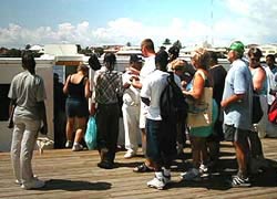 Cruise ship passengers in line inside the Belize Tourist Village to board the small boats that will take them on a tour to the cayes and back to the cruise ship.